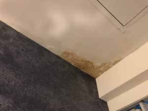 A stained water damaged ceiling leak